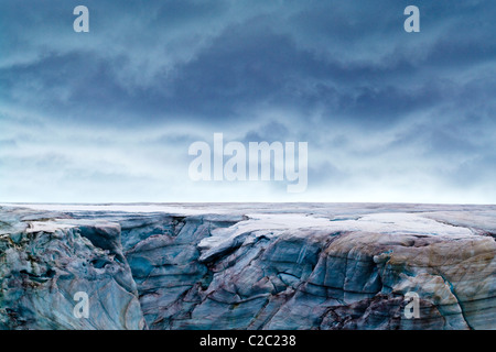 A rugged cold weathered glacier cap with pink Snow Algae, cryoalgae. Stock Photo