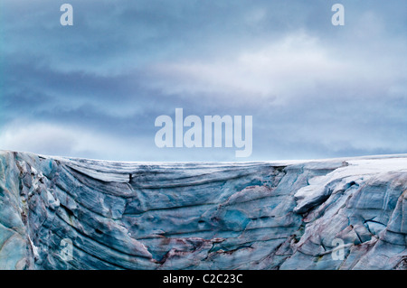 A rugged cold weathered glacier cap with pink Snow Algae, cryoalgae. Stock Photo