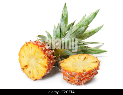fresh pineapple fruit with cut and green leaves isolated on white background Stock Photo