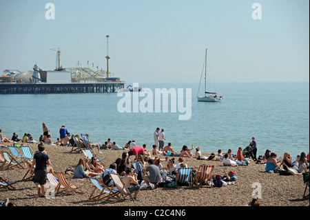 A packed Brighton beach as the UK enjoys unusually good weather for the time of year Stock Photo