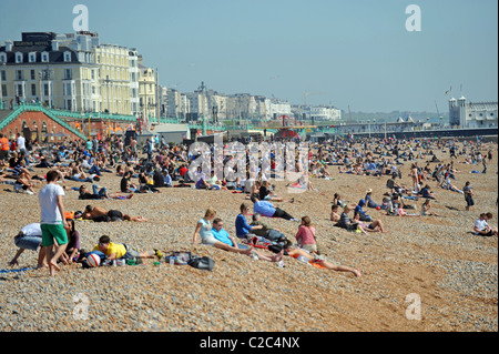 A packed Brighton beach as the UK enjoys unusually good weather for the time of year Stock Photo