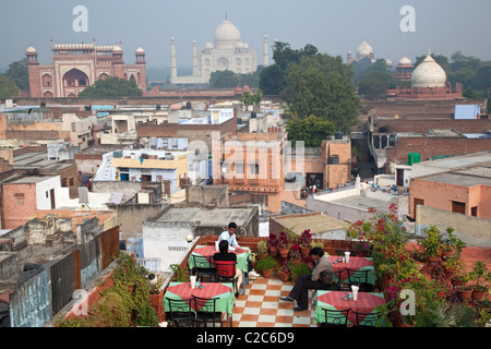 A cityscape shot from a rooftop restaurant with Taj Mahal seen in the distance in Agra, India. Stock Photo