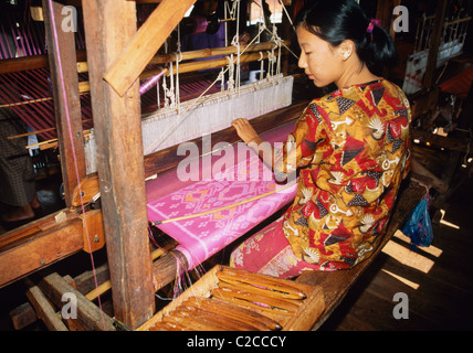 Woman weaving, Textile factory, near Ywama, Lake Inle, Shan State, Myanmar, Asia Stock Photo