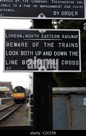 beware of trains sign england uk Stock Photo - Alamy