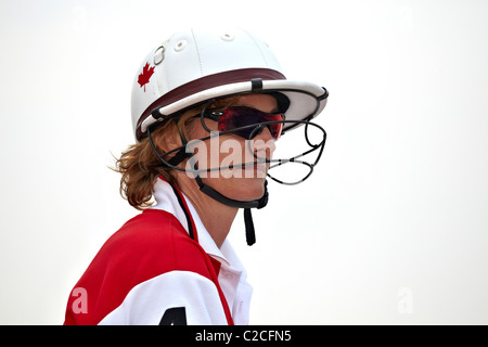 Horse polo safety helmet and face guard worn by a female competitor. Thailand S. E. Asia Stock Photo