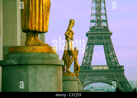 Gilded bronze statue decorating the central square of the Palais de Chaillot with Eiffel Tower in the background. Paris. France Stock Photo
