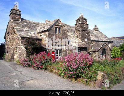Historical Tintagel Old Post Office 14th century Cornish medieval stone hall & house tourist attraction cottage garden & post box Cornwall England UK Stock Photo