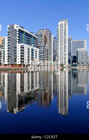 Reflection on water of urban flat apartment housing in real estate development in regeneration of Inner Millwall Dock Isle of Dogs East London UK Stock Photo