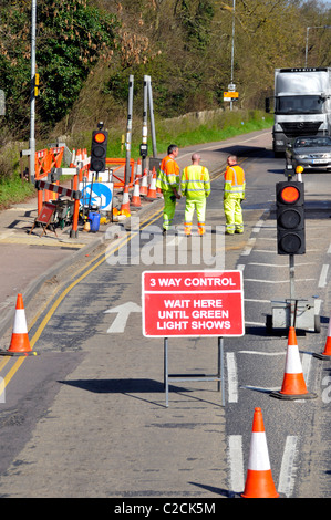 Roadworks signs and temporary traffic lights Stock Photo - Alamy