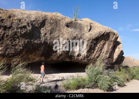 Person standing at Cuevas Amarillas prehistoric rock shelter Big Bend Ranch State Park Texas USA Stock Photo