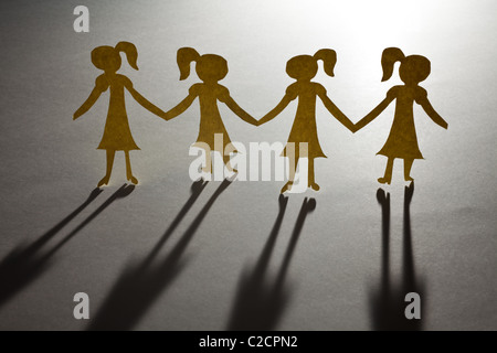 Paper Chain girls, concept of Teamwork Stock Photo