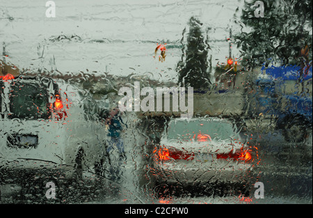 Looking at traffic through a rain covered windshield Stock Photo