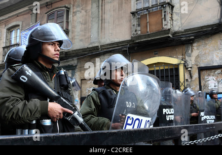 Riot police standing behind security barrier to restrict access to Plaza Murillo during protests, La Paz, Bolivia