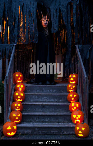 Lit Pumpkins on house steps on Halloween Stock Photo - Alamy