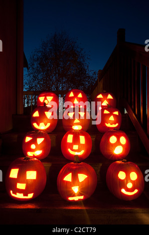 Lit Pumpkins on house steps on Halloween Stock Photo - Alamy