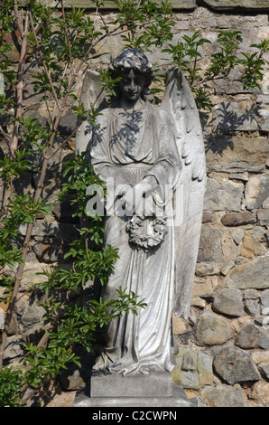 Statue of an angel holding a wreath in the Dean Cemetery Edinburgh, Scotland. Stock Photo