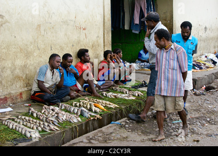 Men selling fish at market, Wamena, Papua, Indonesia Stock Photo