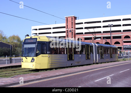 Metrolink tram leaving Harbour City tram stop en route to Eccles from Piccadilly. Stock Photo