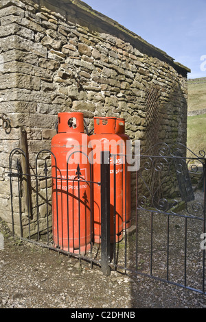 Propane Gas bottles outside a house in Upper Swaledale in the Yorkshire Dales. UK. Stock Photo