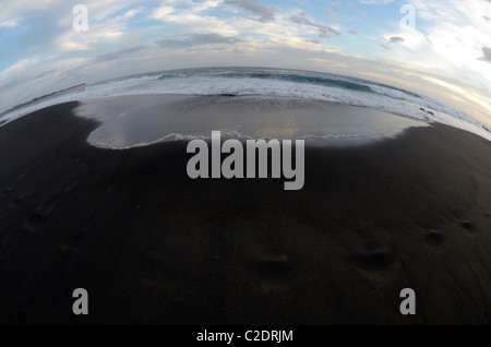 Black sand beach and ocean shot with fish-eye, at Etang-Salé, Reunion island Stock Photo