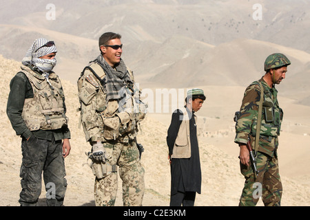 An ISAF soldier and an Afghan soldier on patrol, Feyzabad, Afghanistan Stock Photo