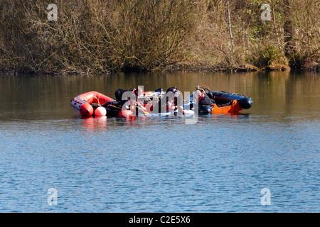 Divers recover a body, thought to be Alfie Skelton from Heathfield Pond in Cobham, Surrey.