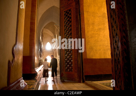 Tourist couple holding hands while walking around Ananda Temple, Bagan, Myanmar Stock Photo