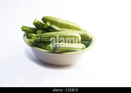 Close-up of fresh zucchini in a bowl on white background Stock Photo