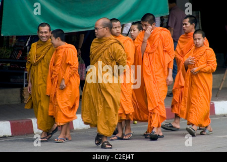 A group of Buddhist monks are enjoying a shopping outing on a city street in Northern Thailand. Stock Photo