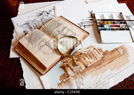 Still life of 15th Century book on Architecture with drawings and magnifying glass Stock Photo
