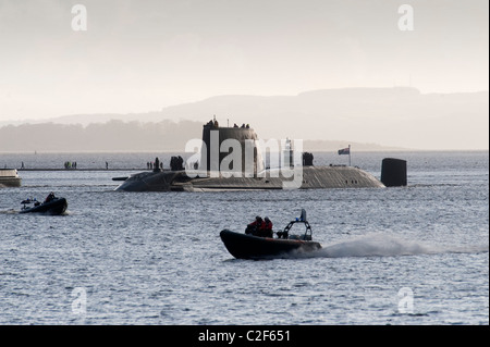 HMS Astute, the Royal Navy's latest nuclear submarine sail up Gareloch on the Firth of Cylde to her new base at HMNB Faslane. Stock Photo