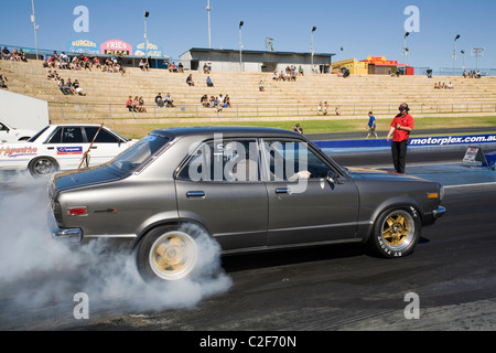 Mazda Rx3 Drag Racing Mazda RX3 drag racing car performing a burnout to heat up the rear ...