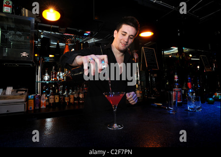 A bartender making cocktails at a club in Brighton Stock Photo