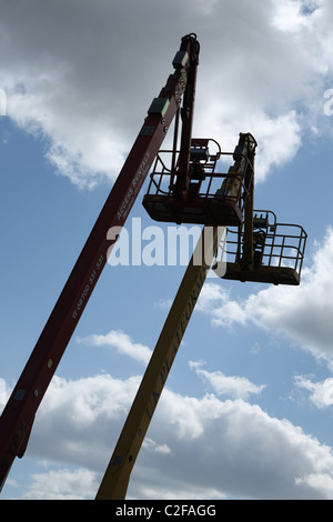 Cherry Pickers against a Spring Sky Stock Photo