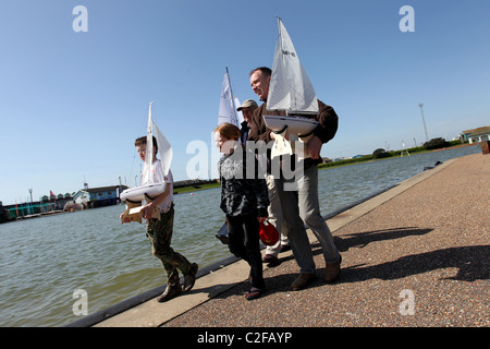 A family pictured at Hove Lagoon with their model sailing boats in Hove, East Sussex, UK. Stock Photo