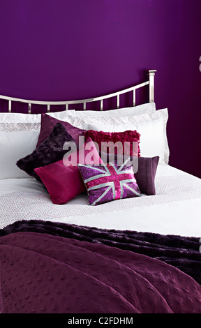 purple painted bedroom purple cushions union jack Stock Photo