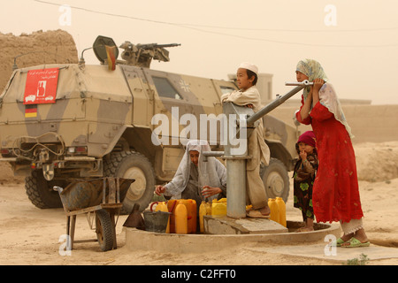 Locals pumping water from a water pump, Kunduz, Afghanistan Stock Photo