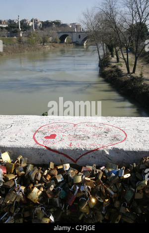 red love heart graffiti and love locks on the milvio bridge in rome, italy Stock Photo