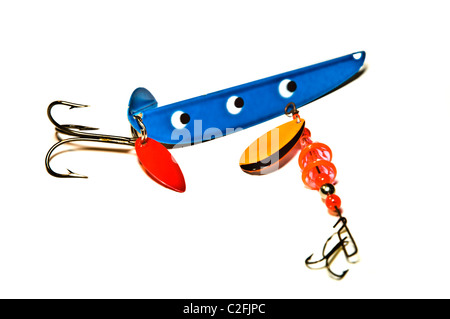 Brightly painted metal and rubber deep sea fishing lures with hooks. Stock Photo