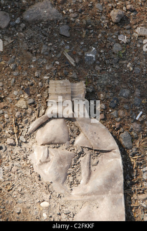 one crushed old plastic water bottle on street road Stock Photo