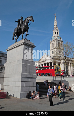 Statue of King George IV in Trafalgar Square with St Martins in the Fields in Central London, UK. Stock Photo