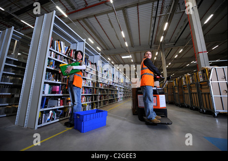 The online retailer Amazon's distribution centre in Swansea, South Wales - employees collect boxes in the 'Sortable Hall' area w Stock Photo