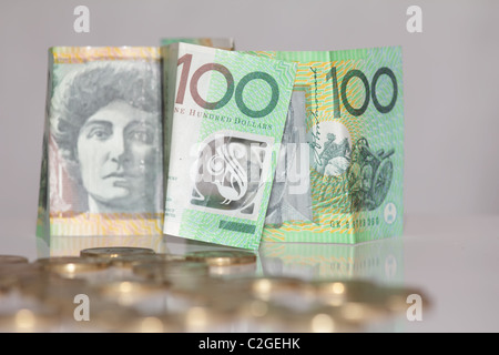 One Hundred Notes in Focus in front of Australian Gold Coins Stock Photo