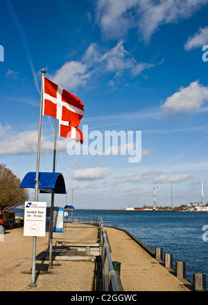 Two Danish (Dannebrog) flags flying waving against a blue sky Copenhagen Strait of Oresund Denmark Scandinavia Europe