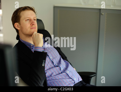 Young businessman in office thinking and planning Stock Photo