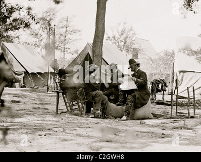 Gen. Ambrose E. Burnside (reading newspaper) with Mathew B. Brady (nearest tree) at Army of the Potomac headquarters Stock Photo