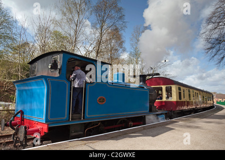 A steam train leaves Lakeside station on the Lakeside and Haverthwaite railway in the lake district on Windermere. Stock Photo