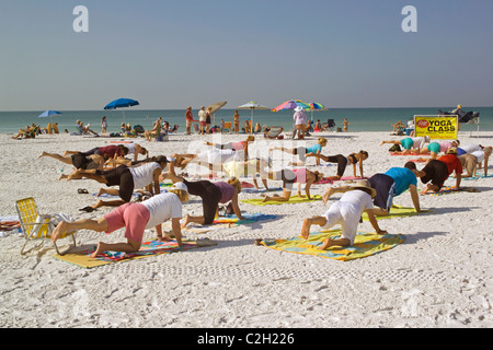 Yoga classes are held on the white sand beach of Siesta Key, a resort barrier island on the Gulf of Mexico at Sarasota, Florida. Stock Photo