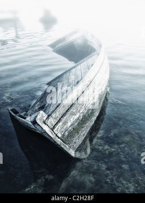 Old abandoned sunken wooden boat in the bay Stock Photo
