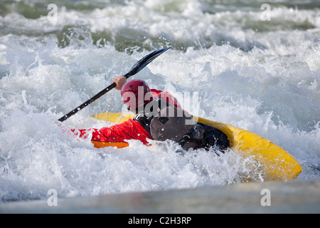 Playboating whitewater kayaker during backsurf on wave, Rhone River near Lyon, Sault Brenaz, France Stock Photo